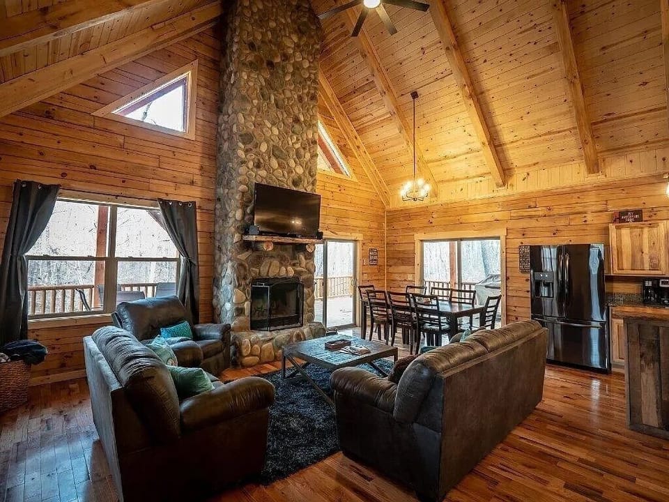 Great Room with wood-burning fireplace connecting to the Kitchen and Dining area