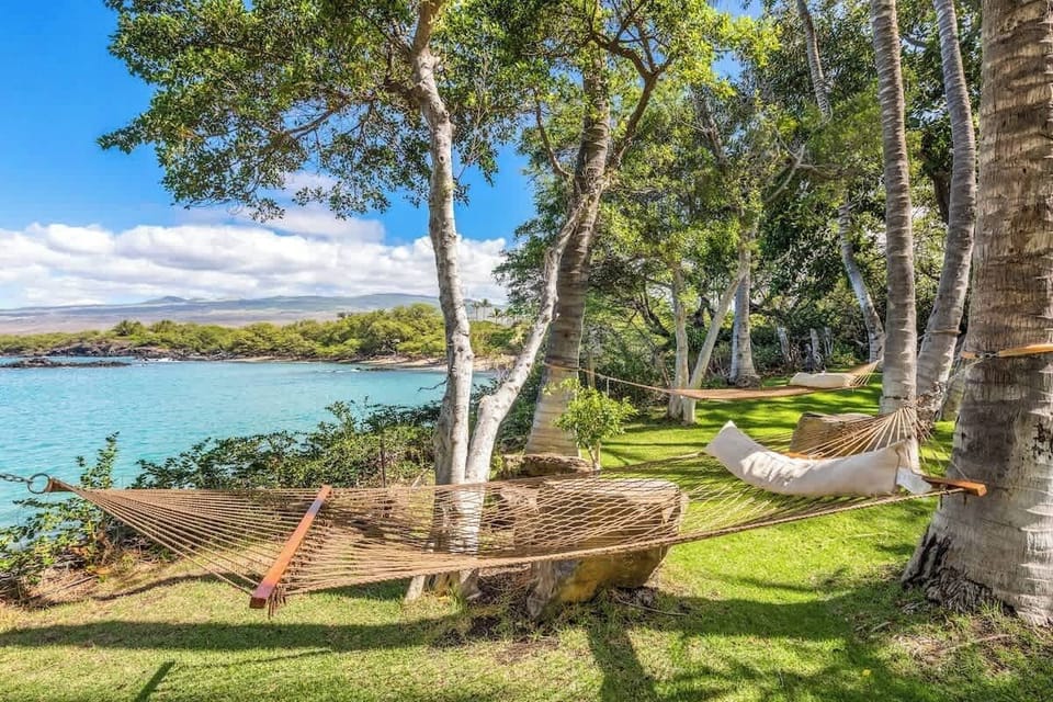 Enjoy the sounds of gentle waves as you relax in a hammock by the sea