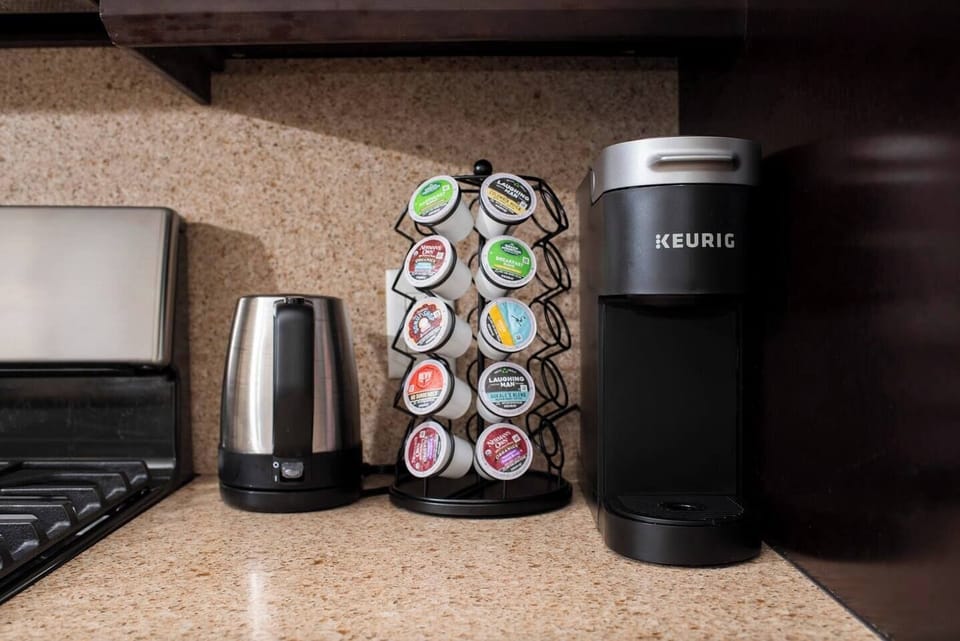 Keurig coffee maker with an assortment of KCups.  There is also an electric kettle and an assortment of teas and also a pour over coffee maker.