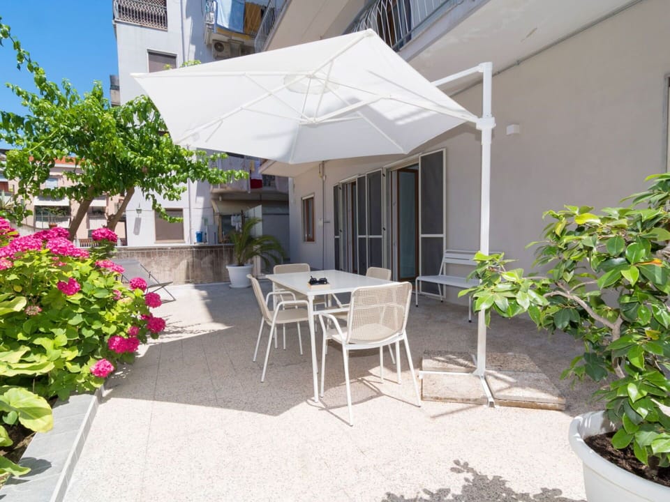 Plant, Building, Flower, Table, Window, Shade, Chair, Outdoor Furniture, Sky, Residential Area