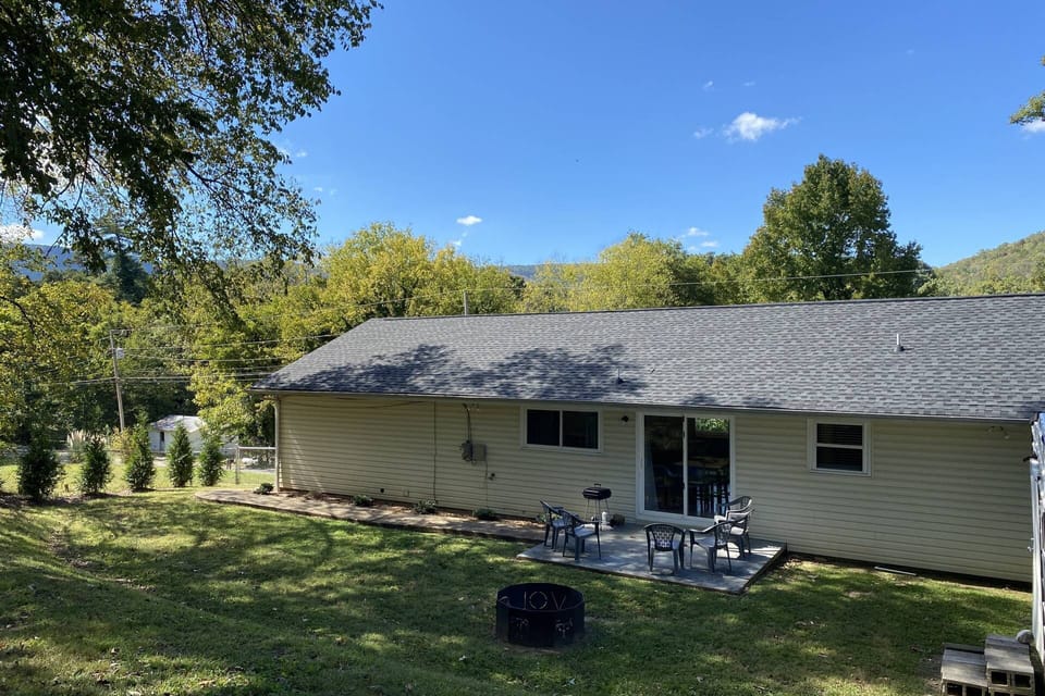 Back patio and spacious yard features seating, grill and fire pit.
