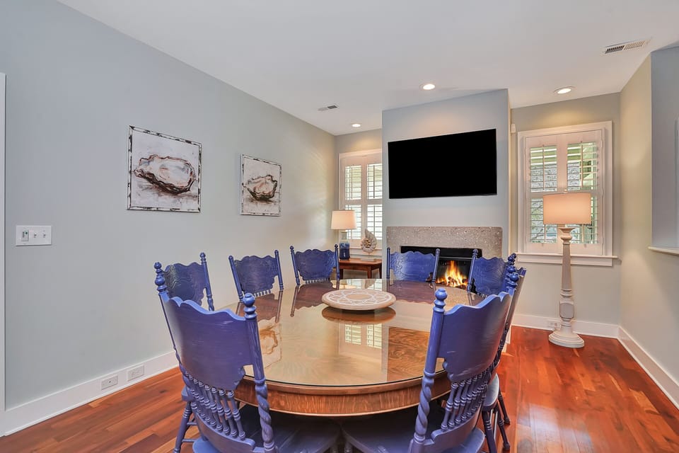 Gather around your elegant dining table while the fireplace crackles warmly. Perfect for intimate meals with loved ones.