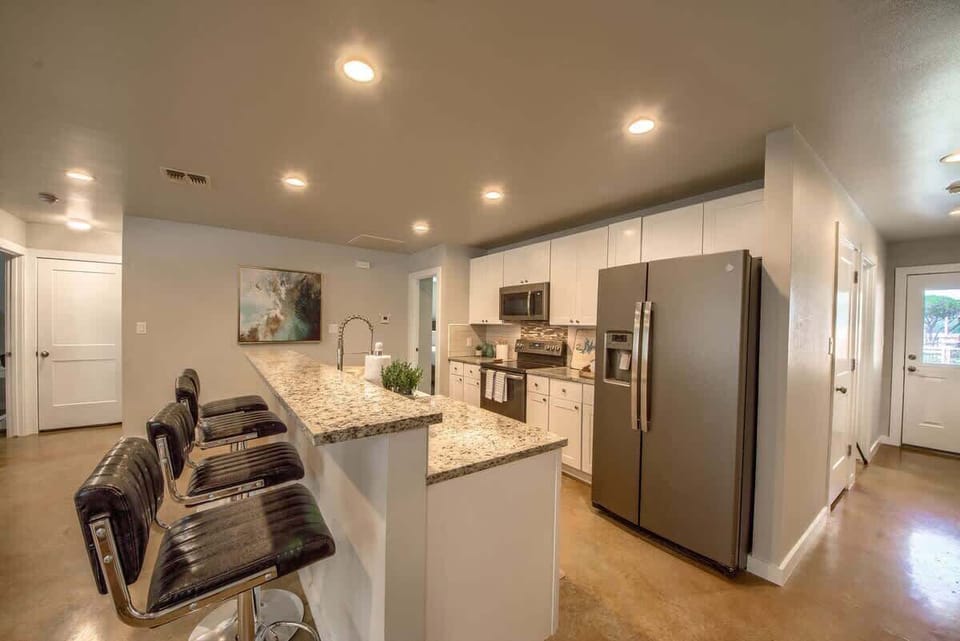 Fully stocked kitchen with bar top seating.