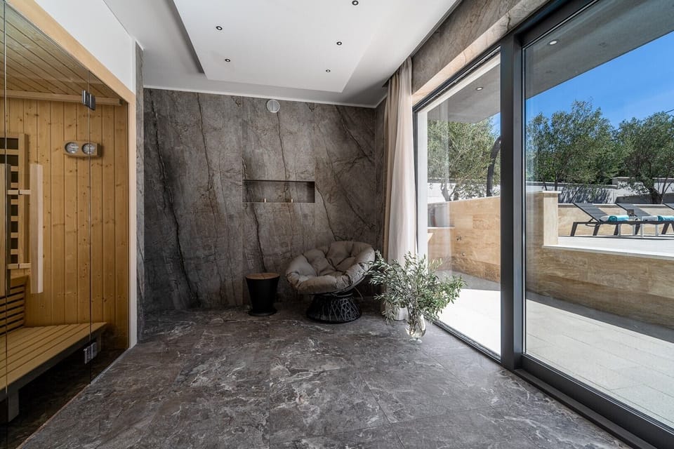 Finnish Sauna room with a shower and glass doors toward the pool area, a very pleasant 15 sqm room for your absolute relaxation