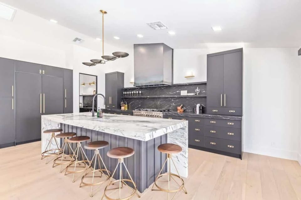 Custom chef's kitchen with dining island and high end appliances + butlers pantry