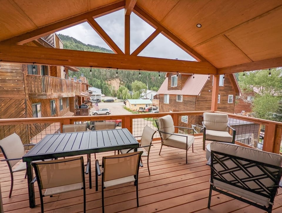 Unwind on your spacious covered deck with comfortable seating and dining for four, framed by mountain vistas and alpine-town charm all around you.