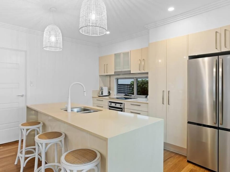 Full kitchen with Nespresso, oven, stove, microwave, dishwasher and island bench