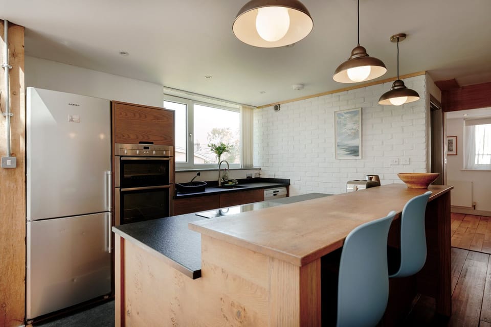 Open plan kitchen and living area featuring a modern, fully equipped kitchen