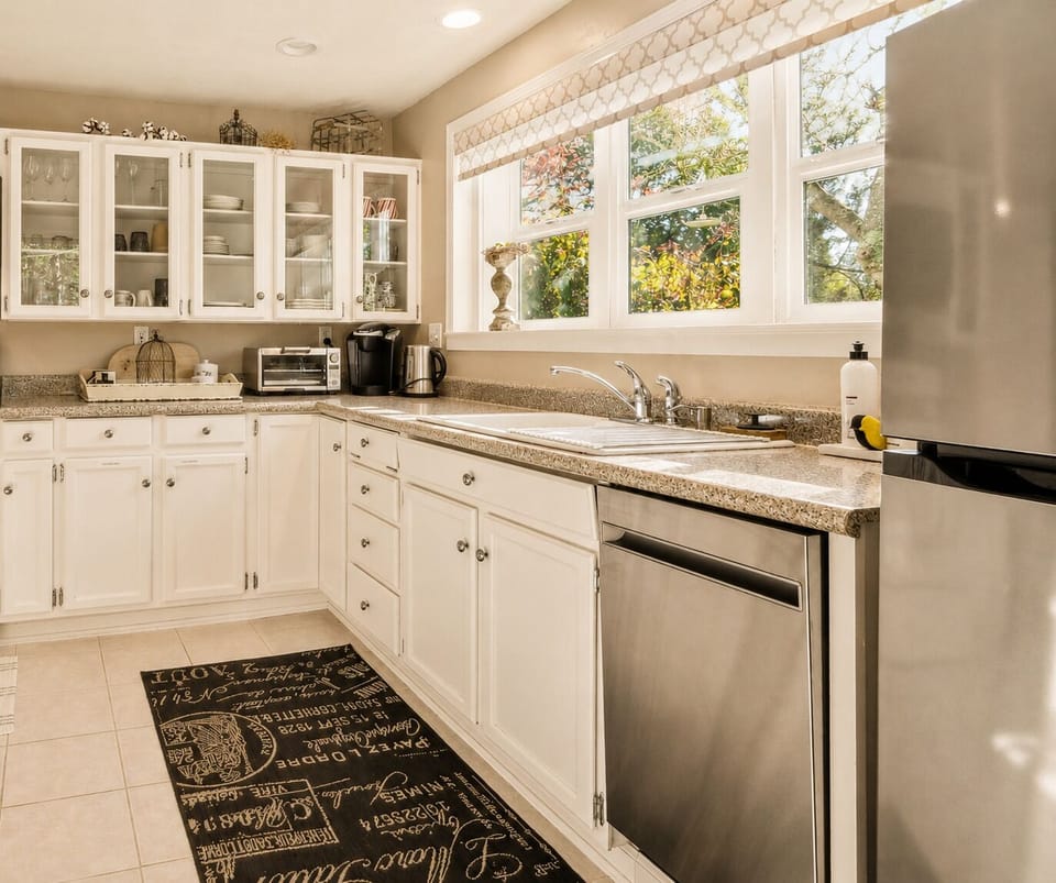 Glass-front cabinetry keeps dishes and cookware easily accessible during your stay