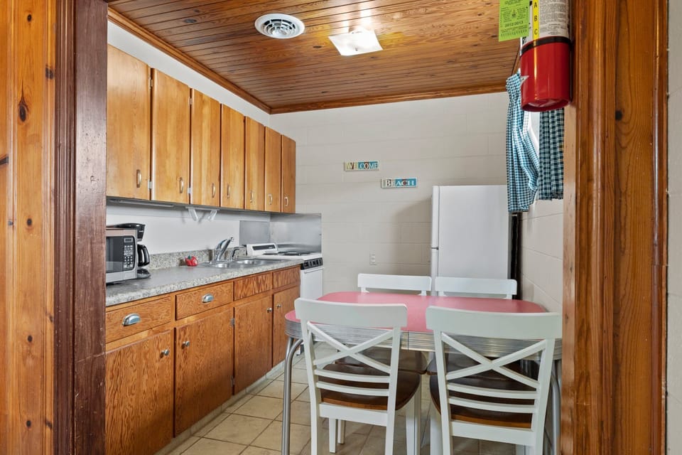 Kitchen with stove, fridge, microwave