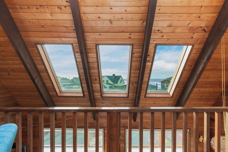 Look up through your private skylights to see blue skies and charming neighborhood rooftops from your cozy wooden loft retreat.