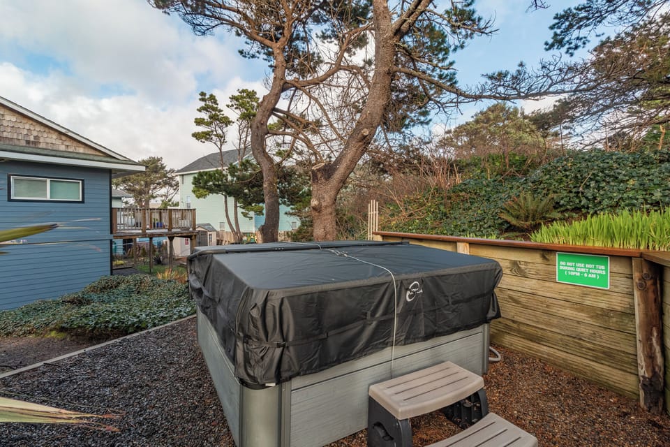 Soak under the stars in your private hot tub, surrounded by mature trees and coastal charm.