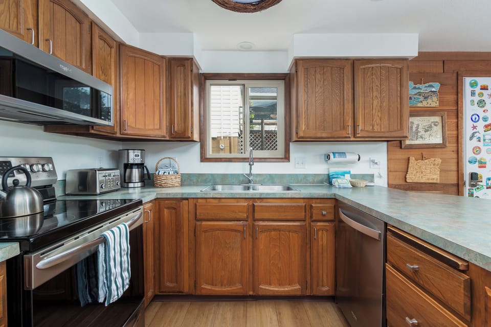 Your fully equipped kitchen awaits with warm wood cabinetry, modern appliances, and everything needed to create memorable meals during your stay.