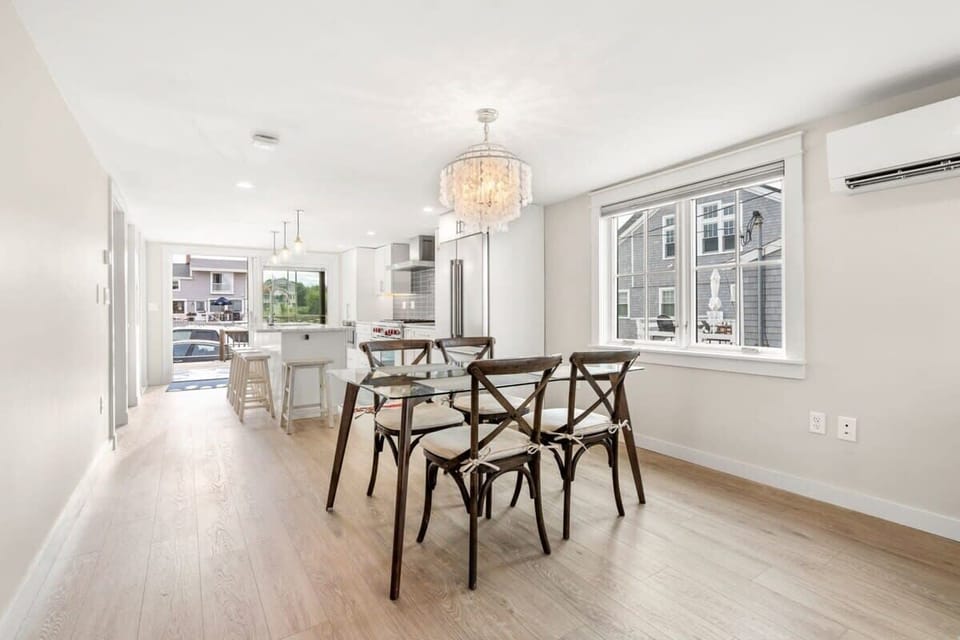 Fully equipped open kitchen and living room with large island, high-end appliances, kitchen table, washer/dryer, smart tv
