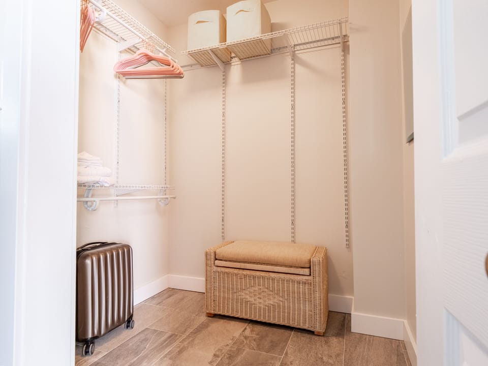 Tropical Bedroom walk in closet.