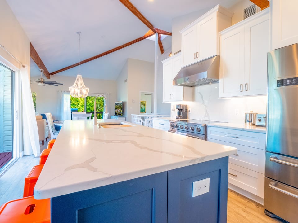Chefs kitchen, quartz countertops and backsplash. Commercial rated 36" range.