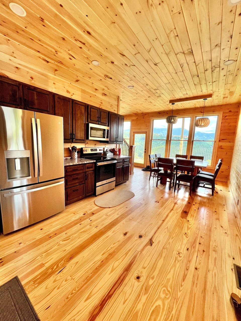 Large eat-in kitchen area with custom handcrafted black walnut cabinets.