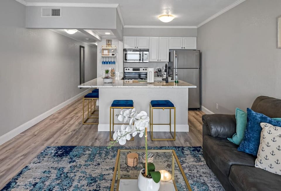 The fully equipped kitchen features a full-sized fridge, stove, and microwave, as well as all the silverware and cooking essentials needed to prepare delicious meals