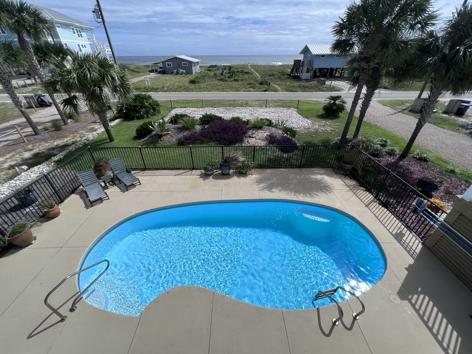 View of the pool and Gulf from the 3rd floor balcony. Mere steps to the beach!