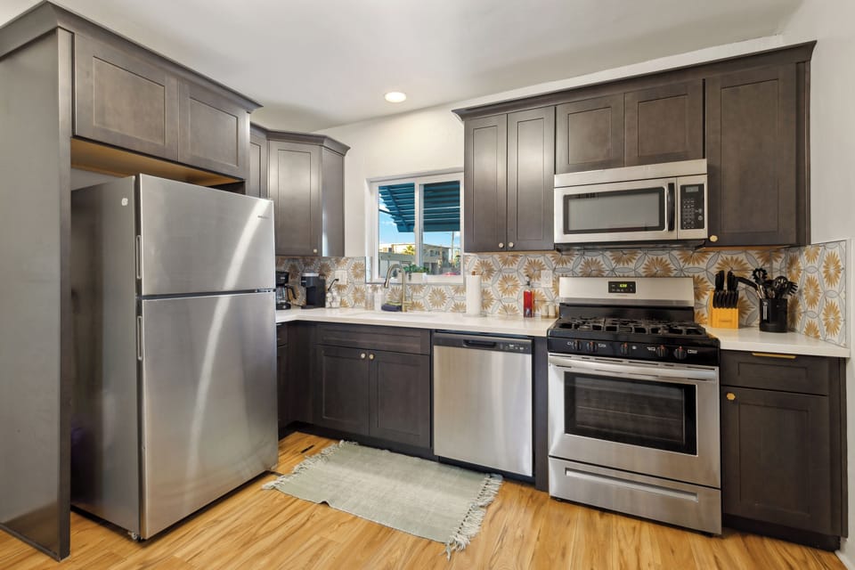 Save money from eating out by cooking meals in this fully remodeled luxury kitchen complete with soft-close doors/drawers, upgraded appliances and quartz counters.