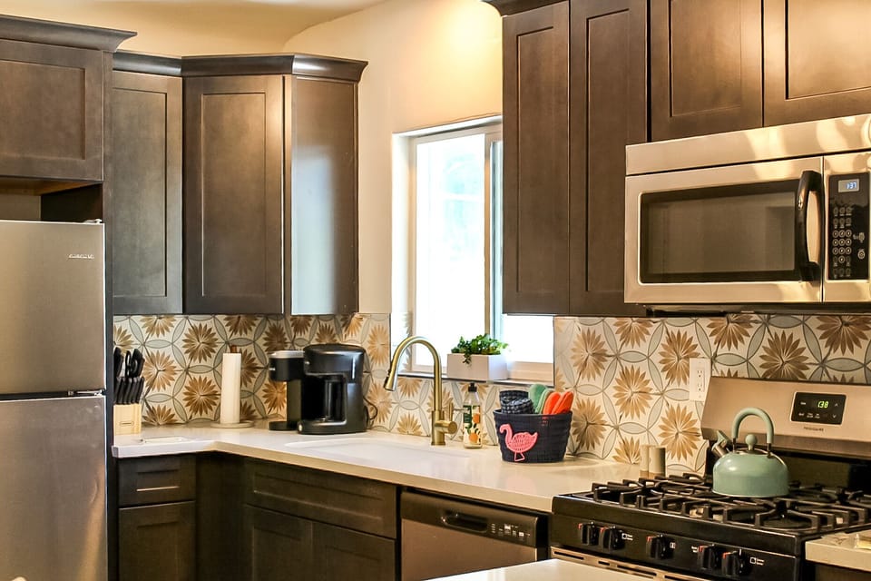 Save money from eating out by cooking meals in this fully remodeled luxury kitchen complete with soft-close doors/drawers, upgraded appliances and quartz counters.