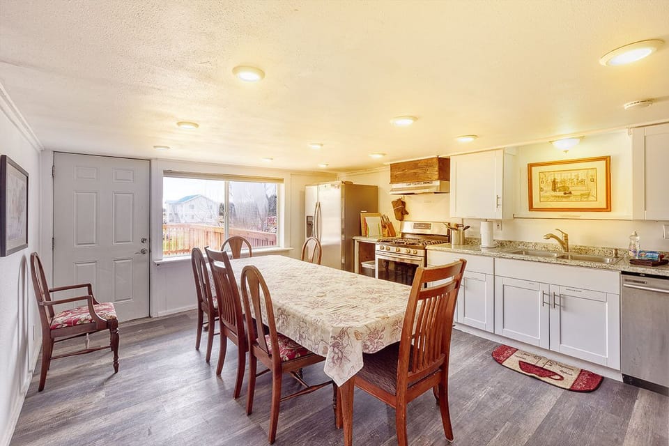The dining area showcases a wooden table with seating for six.