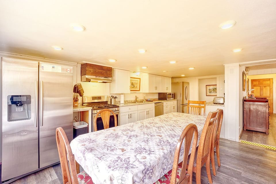 The dining area showcases a wooden table with seating for six.