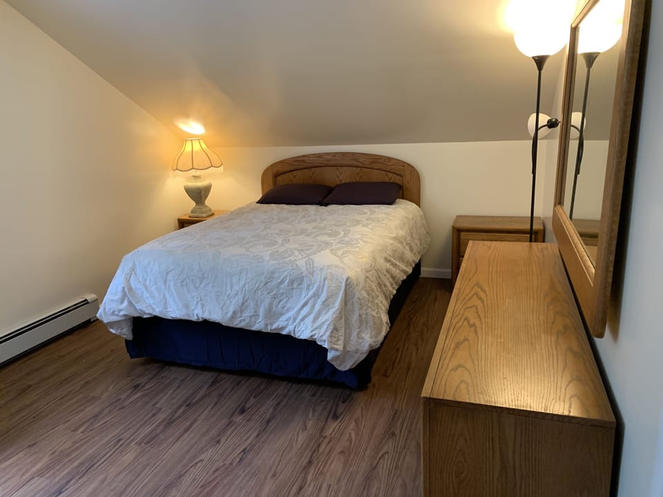 2nd floor bedroom w/ queen bed, window AC and 40” TV