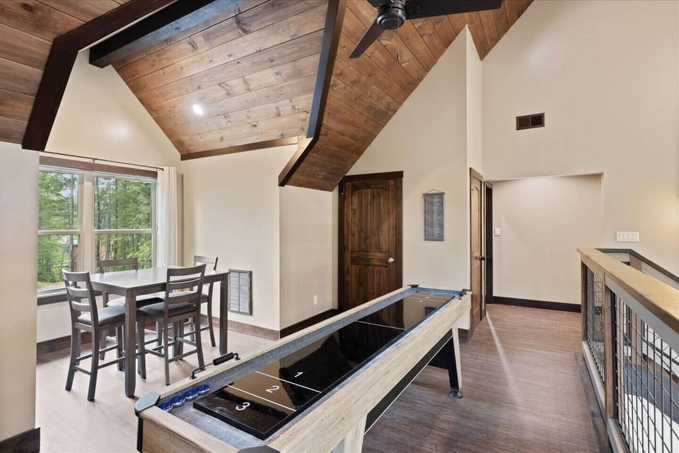 Upper level game loft with shuffleboard table and a gathering table for boardgames!
