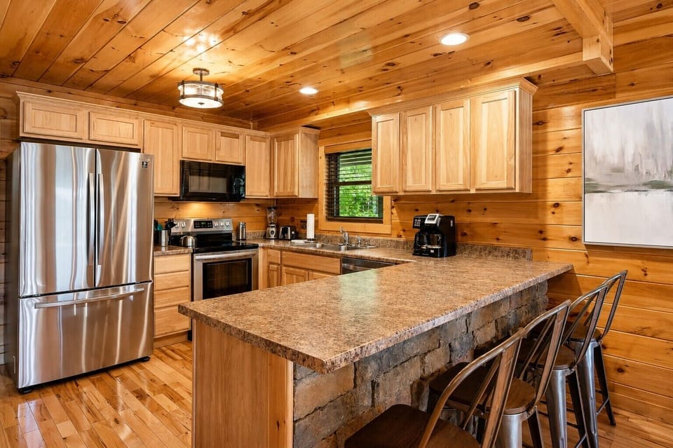 Fully stocked kitchen with breakfast bar and updated appliances.