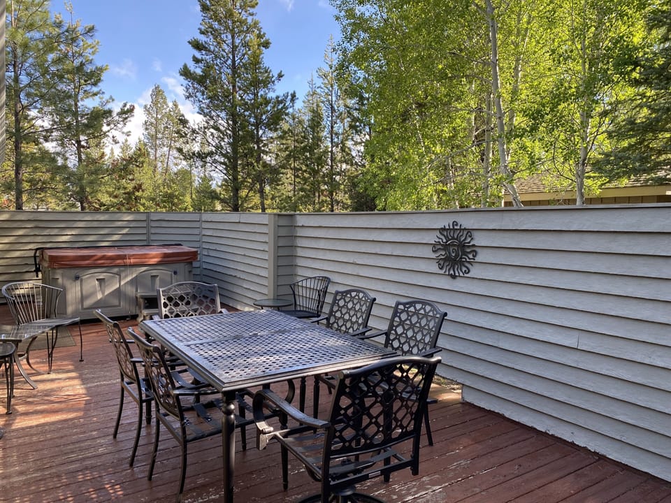 Deck with newer patio furniture, propane gas grill and hot tub