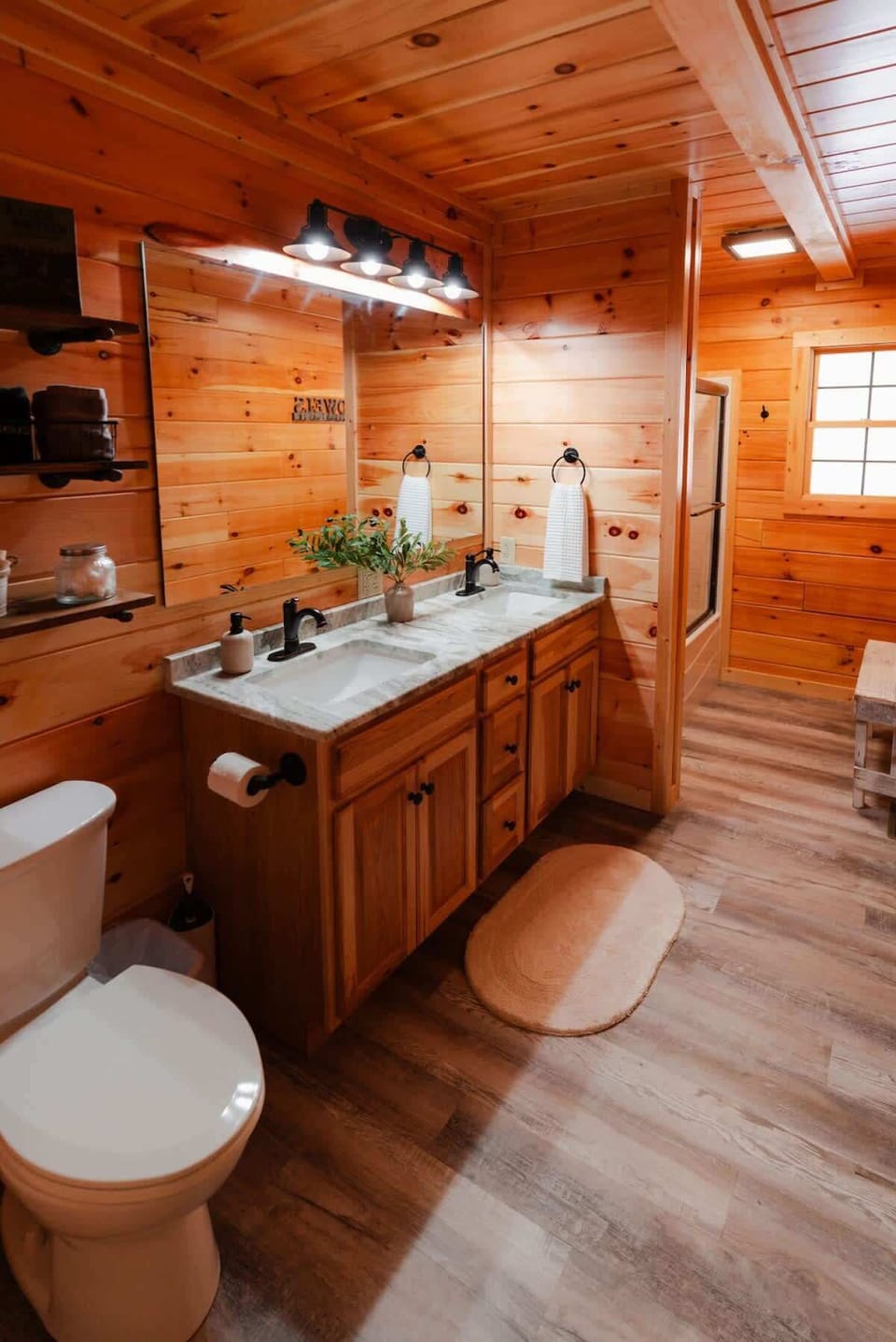 Master Bathroom: Elegant dual sinks and rustic charm await in this serene retreat!