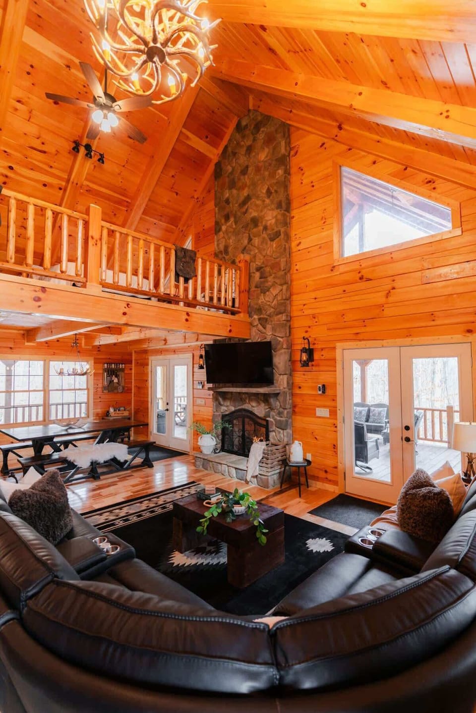 Living Room: Experience warmth with stunning wood accents and plush seating around the stone fireplace!