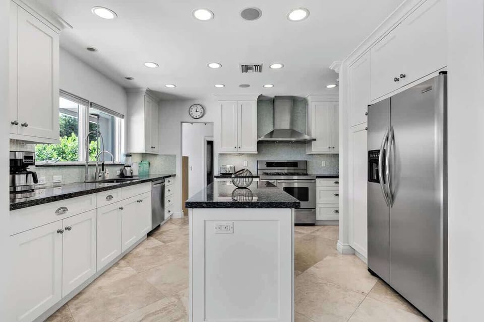 Bright dining space with modern design—perfect for vacation rentals and short-term stays. Enjoy stylish seating, minimalist decor, and a welcoming vibe ideal for group meals and relaxing getaways.