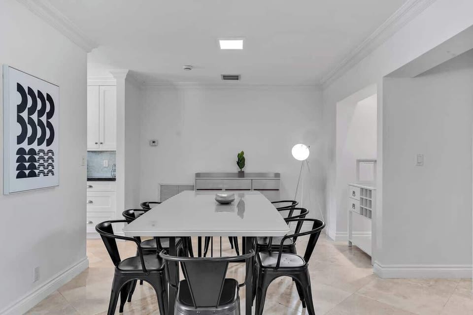 Bright dining space with modern design—perfect for vacation rentals and short-term stays. Enjoy stylish seating, minimalist decor, and a welcoming vibe ideal for group meals and relaxing getaways.