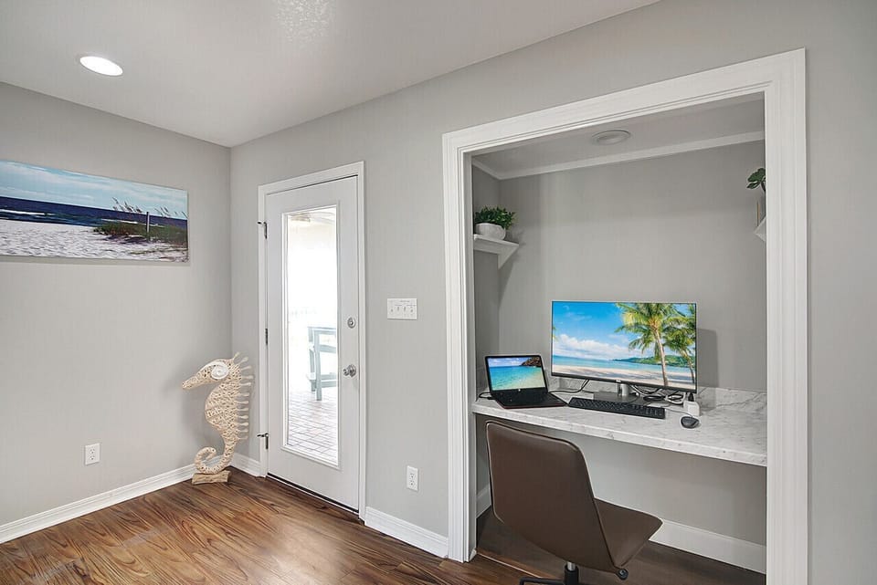 Office workspace located in the second floor landing. Includes monitor and power