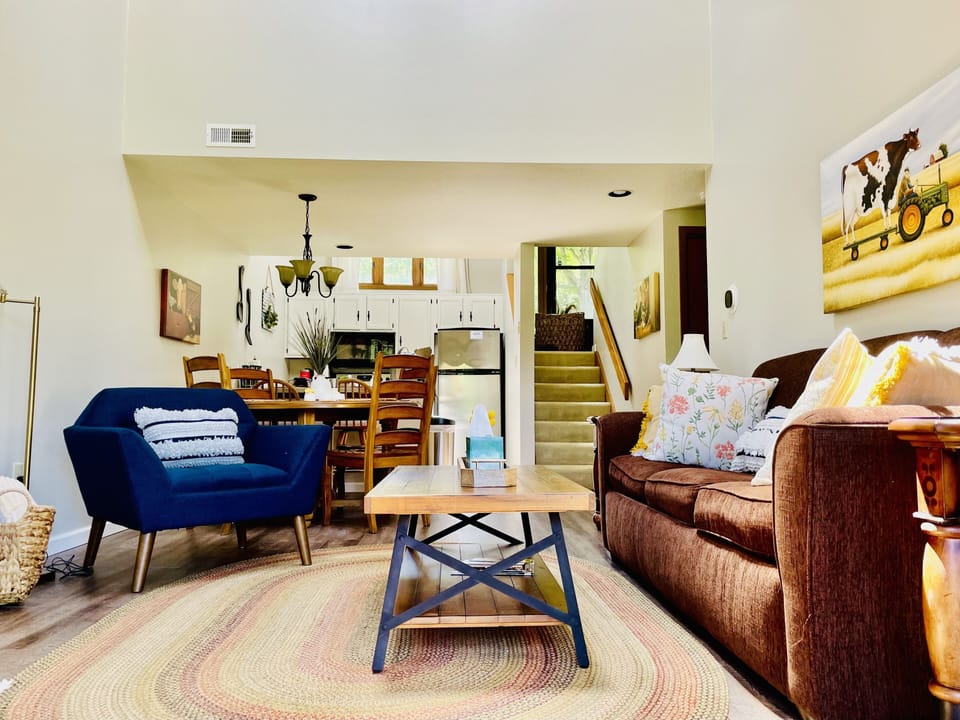 Stairs from the living room lead to the upper-level bedroom.