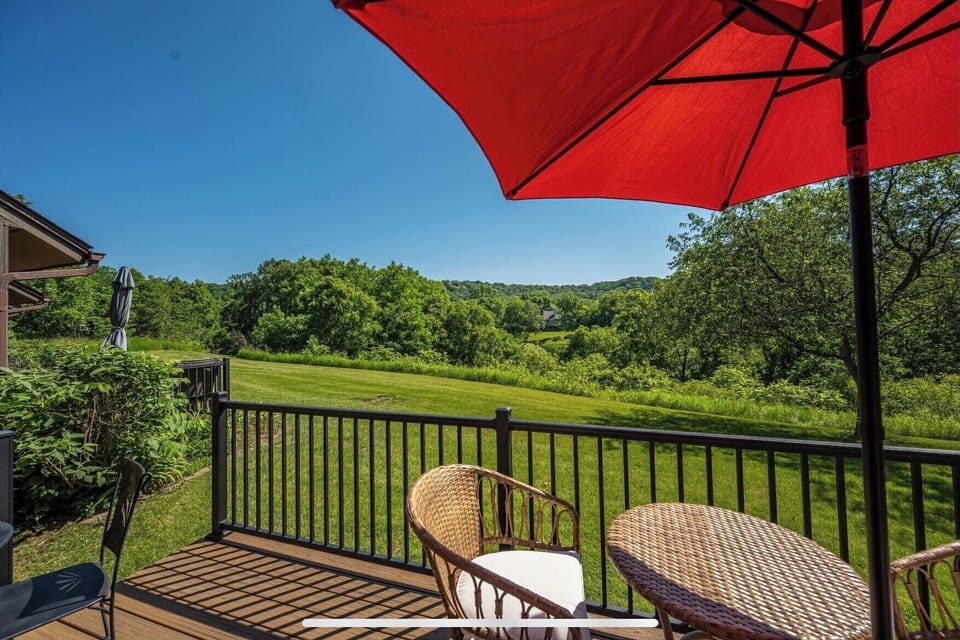 Living room opens to a patio with scenic rolling hill views.