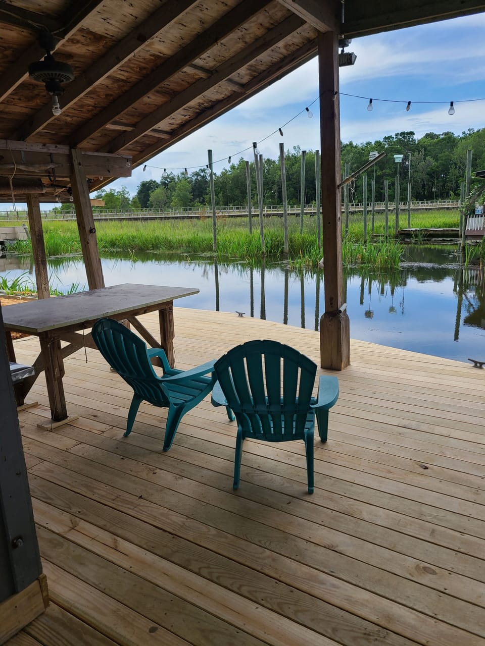 Boat house with amazing atmosphere....Come feed the fish!