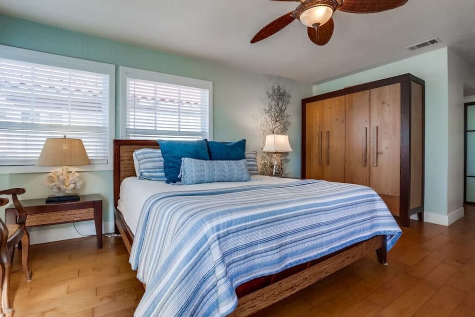 Primary bedroom with ocean views, king bed, smart TV, and en-suite bath