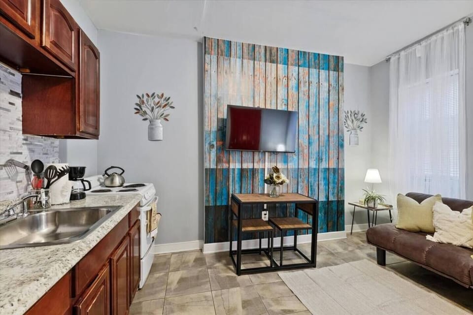 Open-concept living and kitchen area with hardwood floors maximizing space.