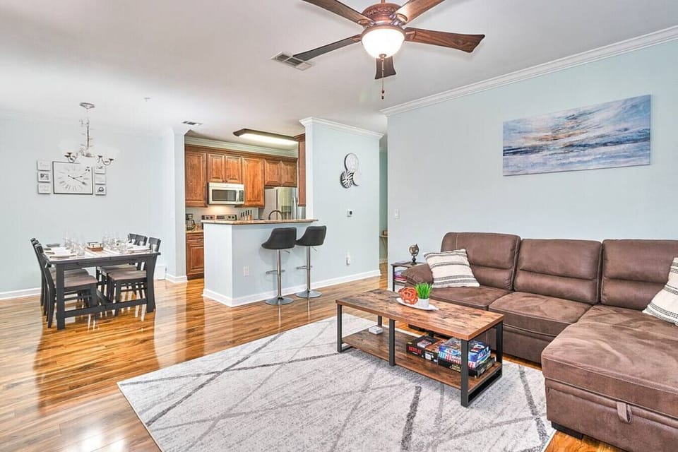 Experience ultimate comfort in the living room with a sofa, TV, TV cabinet, ceiling fan, and a lamp