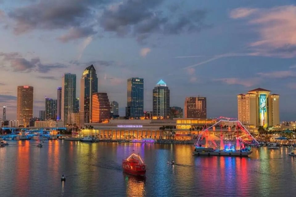 Downtown Tampa FL at dusk. View of the Tampa Convention center and downtown Tampa skyline, Hillsborough River connecting to the Tampa Bay. The infamous pirate ship highlighted. People in Tampa love pirates for some reason.