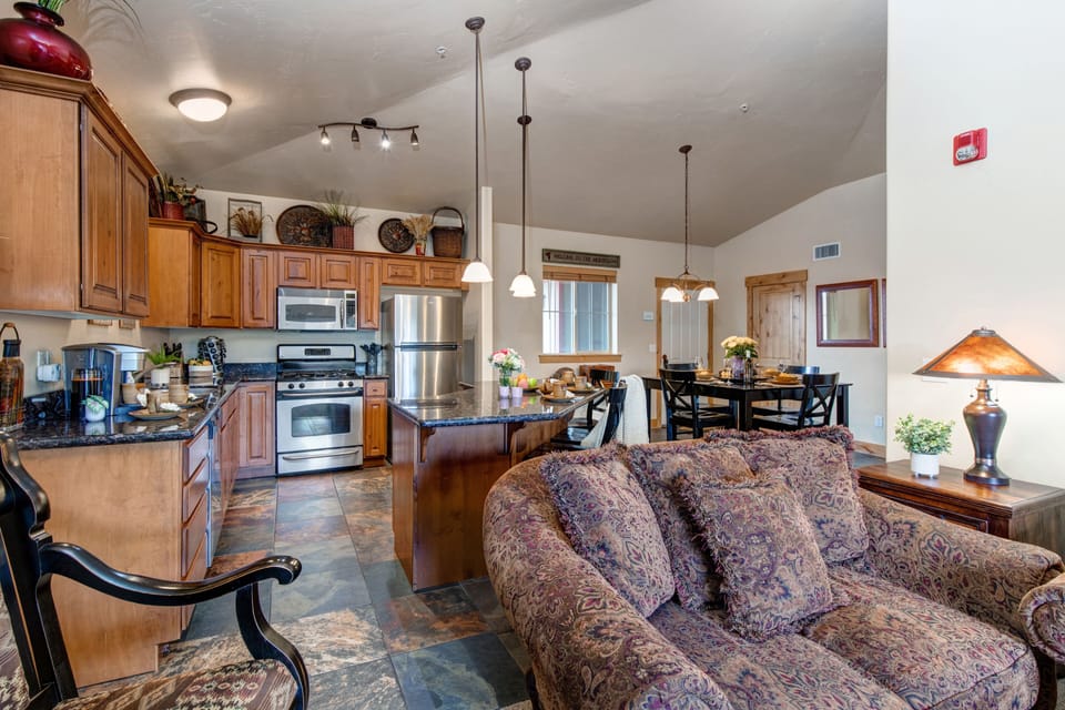 Living Room with plush sofa & loveseat, gas fireplace, 50" TV, and private deck access