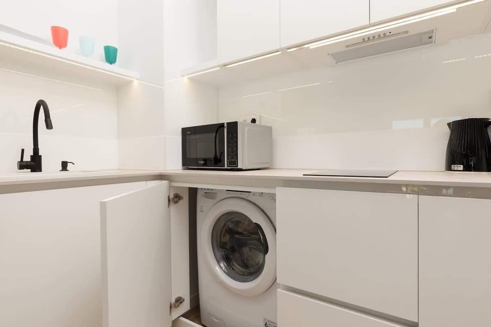 The sleek design of the kitchenette blending seamlessly with the living area.