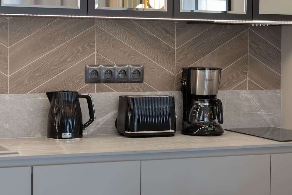 The sleek design of the kitchenette blending seamlessly with the living area.
