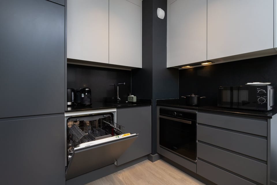 The sleek design of the kitchenette blending seamlessly with the living area.