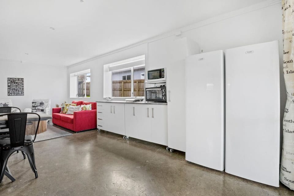 The main living space consists of an open plan living room, kitchenette and dining space.