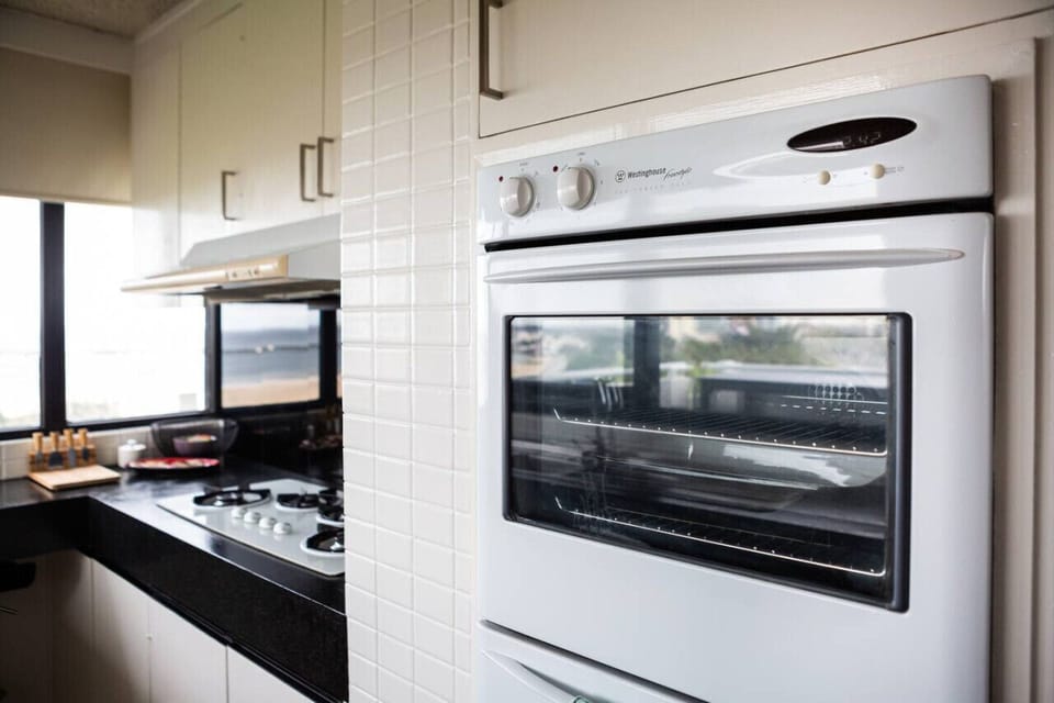 Modern fully equipped kitchen with cooking appliances, microwave, pots, pans and plenty of cooking utensils for the times you just want to stay in.