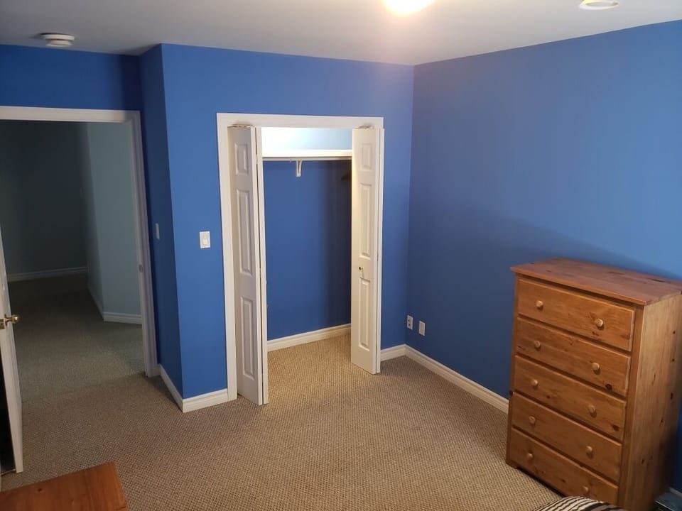 Bedroom 2 with bright airy feel from queen sized bed and lake view from window